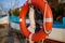 Orange lifebuoy hang on the pier