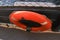 Orange lifebuoy hanging on a boat, sea view.