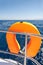 Orange lifebuoy on sailing ship