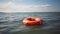 Orange lifebuoy on the water in the blue sea. Safety on the water, rescue of a drowning person