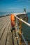 Orange lifeguard ring on a pier