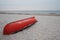 Orange lifeguard`s rescue boat upside down on beach at Baltic coast