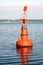 Orange light buoy in ocean