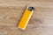 Orange lighter on wooden background