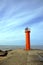 Orange lighthouse on Mangalsalas mols, Riga, Baltic sea