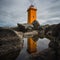 Orange lighthouse at the westcoast of Iceland