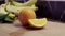 Orange and little piece on cutting board. Bananas and spinach on background