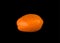 Orange long tomato on a black background