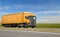 Orange lorry with trailer