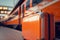 Orange luggage at railway station in front of a train made with Generative AI. Travel by train advertisement poster concept