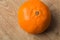 Orange mandarine fruit skin texture on a wooden board