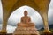 Orange marble buddha statue in meditation pose