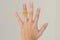 Orange massage ring around persons finger