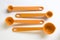 Orange measuring spoons, stacked