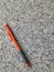 Orange mechanical pencil on granite