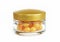 Orange medical capsules with aromatic oil in a glass jar