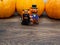 Orange miniature ceramic pumpkin guy with black cat with three orange pumpkins on the background