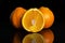 Orange minneola tangelo isolated on black glass