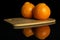 Orange minneola tangelo isolated on black glass