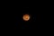 An orange moon at night