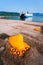 Orange Mooring Bollard and big ferry boat with passengers and cars arrives beautiful greek island. Summer vacation