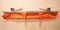 Orange multi functional aluminium ambulance stretcher, used to carry someone down the stairs