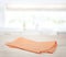 Orange napkin,folded kitchen towel,picnic cloth on wooden table empty space backdrop