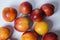 Orange nectarines on a white background