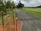 Orange netting along park pathway