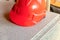 Orange new helmet plastic builder protection falling building materials close-up design base