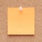 Orange note on a corkboard