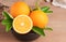 orange.orange fruits background many orange fruits. Oranges group freshly picked in a basket and on a brown wooden table