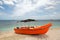 Orange panga / fishing boat on coral beach in Sri Lanka