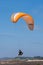 Orange paraglider at Torrey Pines Gliderport in La Jolla