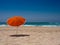 Orange parasol on the beach