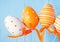 Orange patterned easter eggs on blue background