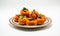 orange persimmons on a small plate on white