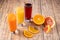 Orange, pineapple and cherry juices in glass glasses.