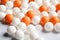 Orange ping pong balls surrounded with white balls generative AI