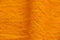 Orange plain fabric as a background closeup