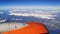 Orange plane flies over the Turkish mountains covered with snow and Mediterranean Sea - view from the airplane window 15