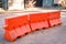 Orange plastic barrier lined up on the road