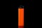 Orange plastic cigarette lighter on black background, closeup