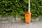 Orange Plastic Public Trash Cans at Pole