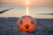 Orange plastic soccer ball at the beach