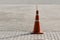 Orange Plastic traffic cone on the road