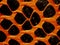 Orange plastic vynil mesh detail used for snow fence along roads