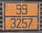 Orange plate with hazard identification number on bitumen tank
