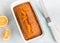 Orange Pound Cake in a Baking Loaf Pan on White Background Top Down Flat Lay horizontal Photo