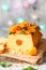 Orange Pound Cake flavored with freshly squeezed orange juice and zest decorated with dried apricots, mint and almonds